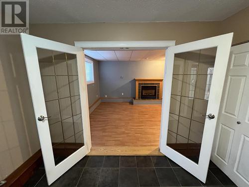 5207 Sunset Drive, Fort Nelson, BC - Indoor Photo Showing Other Room With Fireplace