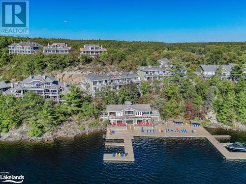 Looking onto the docks - 1869 Muskoka 118 Highway W Unit# A201-C1 Or C2, Muskoka Lakes, ON - Outdoor With Body Of Water With View