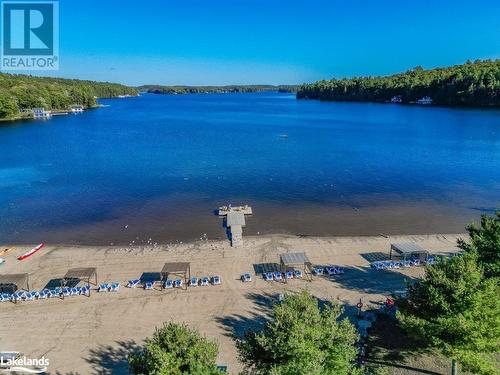 Beach view - 1869 Muskoka 118 Highway W Unit# A201-C1 Or C2, Muskoka Lakes, ON - Outdoor With Body Of Water With View