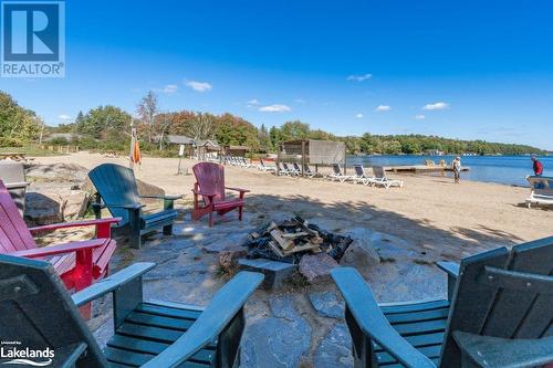 Firepit at the beach - 1869 Muskoka 118 Highway W Unit# A201-C1 Or C2, Muskoka Lakes, ON - Outdoor With Body Of Water With Deck Patio Veranda With View