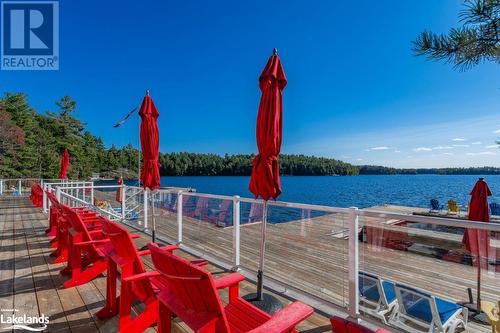 Sitting on the dock at boathouse - 1869 Muskoka 118 Highway W Unit# A201-C1 Or C2, Muskoka Lakes, ON - Outdoor With Body Of Water