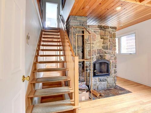 Staircase - 51  - 53 Rue St-Antoine, Sainte-Agathe-Des-Monts, QC - Indoor Photo Showing Other Room With Fireplace
