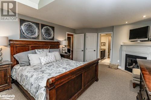 3876 Muskoka 118 Road W Unit# Carling 6-W5, Port Carling, ON - Indoor Photo Showing Bedroom With Fireplace