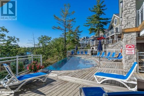 Infinity pool at Main Lodge - 1869 Muskoka Road 118 Highway W Unit# A104-C2, Muskoka Lakes, ON - Outdoor With In Ground Pool With Deck Patio Veranda