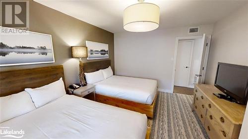 spacious bedroom with two queen beds - 1235 Deerhurst Drive Unit# 51-208, Huntsville, ON - Indoor Photo Showing Bedroom