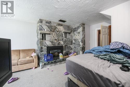 8020 Gravenstein Drive, Osoyoos, BC - Indoor Photo Showing Bedroom With Fireplace