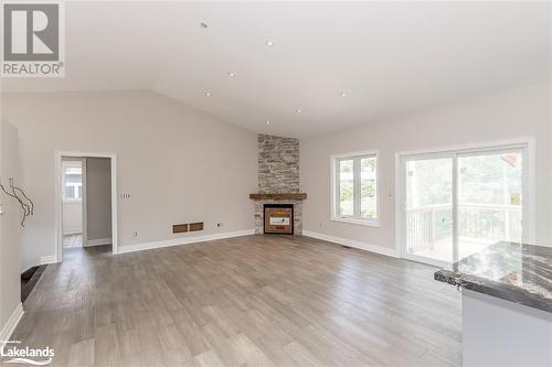 Home Previously Built - similar model - Lot 13 Voyageur Drive, Tiny, ON - Indoor Photo Showing Living Room With Fireplace