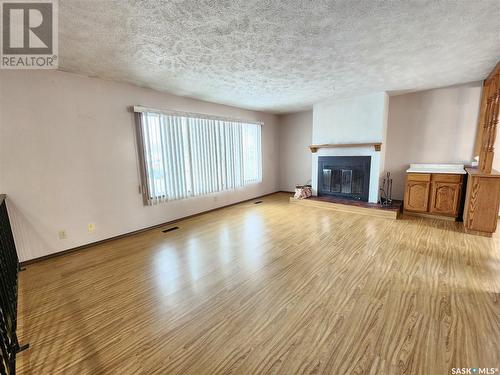 571 13Th Street Ne, Weyburn, SK - Indoor Photo Showing Living Room With Fireplace