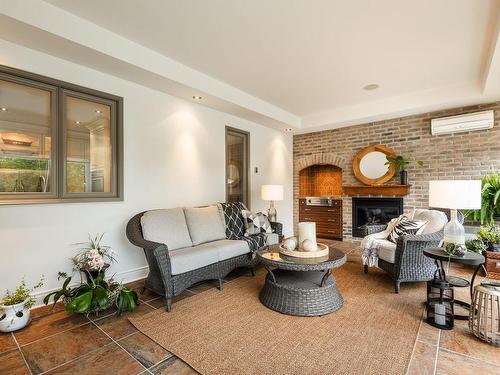 Veranda - 119 Rue Antoine-Forestier, Carignan, QC - Indoor Photo Showing Living Room With Fireplace