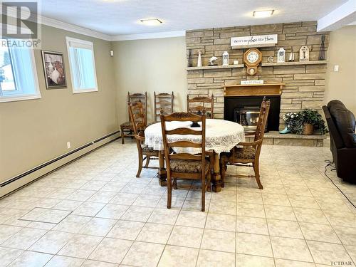 121 St-Aubin Ave, Moonbeam, ON - Indoor Photo Showing Dining Room With Fireplace