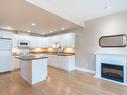 101-193 Second Ave West, Qualicum Beach, BC  - Indoor Photo Showing Kitchen With Fireplace 