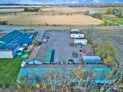 Storage compound, fully fenced with locking gate.  Contains a wood shop and 10 bay storage building. - 