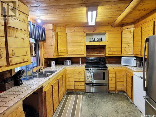 715 Chitek Drive, Chitek Lake, SK - Indoor Photo Showing Kitchen With Double Sink