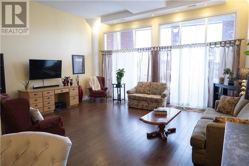 Large living room with floor to ceiling windows and two sets of patio doors to balcony - 710 Cotton Mill Street Unit#206, Cornwall, ON - Indoor Photo Showing Living Room