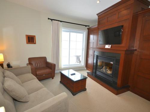 Living room - 302-6385 Mtée Ryan, Mont-Tremblant, QC - Indoor Photo Showing Living Room With Fireplace