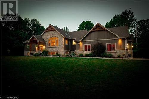 This extraordinary estate situated on almost 50 acres at Berford Lake showcases a magnificent custom-built home adorned with stone and exquisite timber frame accents, offering a total of 4,600 square - 3 Teddy Bear Lane, South Bruce Peninsula, ON - Outdoor With Facade