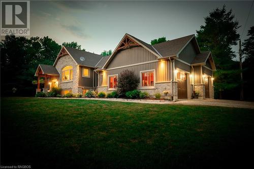 This extraordinary estate situated on almost 50 acres at Berford Lake showcases a magnificent custom-built home adorned with stone and exquisite timber frame accents, offering a total of 4,600 square - 3 Teddy Bear Lane, South Bruce Peninsula, ON - Outdoor With Facade