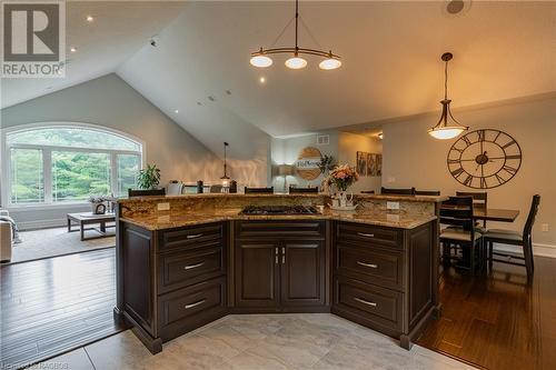 Open elegance to maximize family time. The kitchen island with Brazilian granite and  countertop range seamlessly overlooks the open-concept design living room with impressive vaulted ceiling. - 3 Teddy Bear Lane, South Bruce Peninsula, ON - Indoor
