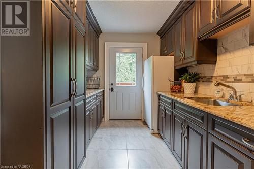 A hidden gem of convenience, discover the exquisite butler's pantry, a culinary retreat just steps away from the main kitchen and offering walkout to the raised deck. - 3 Teddy Bear Lane, South Bruce Peninsula, ON - Indoor Photo Showing Kitchen