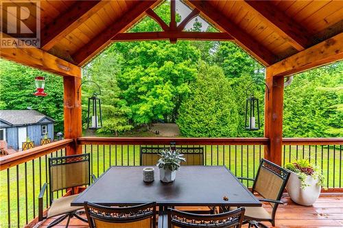 Unwind in serenity: timber-framed covered back porch with tongue and groove ceiling, the perfect retreat for relaxation and outdoor bliss. - 3 Teddy Bear Lane, South Bruce Peninsula, ON - Outdoor With Deck Patio Veranda With Exterior