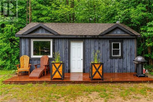 The original board and batten cottage adds a touch of history and allure, perfect for hosting guests or providing additional living quarters. - 3 Teddy Bear Lane, South Bruce Peninsula, ON - Outdoor