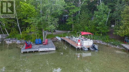 Dock (on Right with red pontoon boat) on Berford Lake accessed via Right of Way. - 3 Teddy Bear Lane, South Bruce Peninsula, ON - Outdoor With Body Of Water