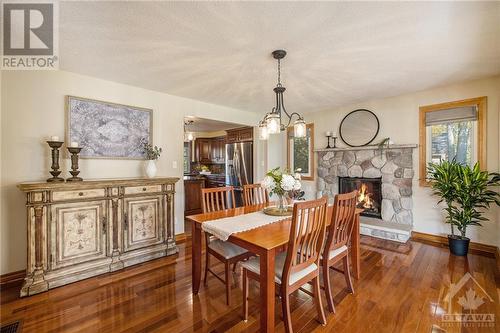 145 Manor Way, Rideau Ferry, ON - Indoor Photo Showing Dining Room With Fireplace
