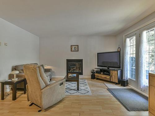 Living room - 32 Ch. De La Flore, Sainte-Anne-Des-Lacs, QC - Indoor Photo Showing Other Room With Fireplace
