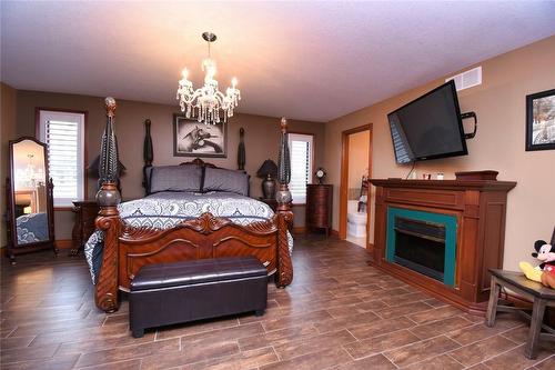 85 Unity Side Road, Caledonia, ON - Indoor Photo Showing Bedroom With Fireplace