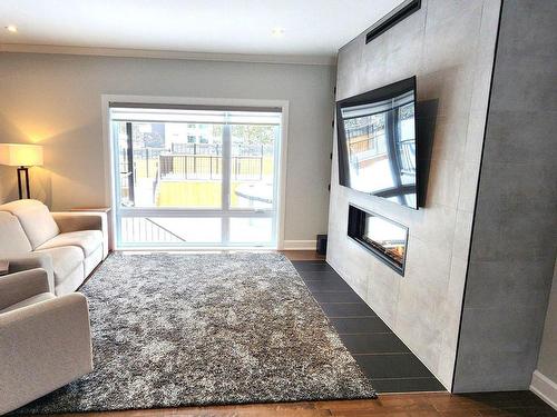 Living room - 16985 Rue Du Zircon, Mirabel, QC - Indoor Photo Showing Living Room With Fireplace