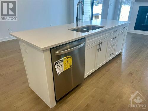 large kichen island with beakfast bar - 82 Bon Temps Way, Ottawa, ON - Indoor Photo Showing Kitchen With Double Sink