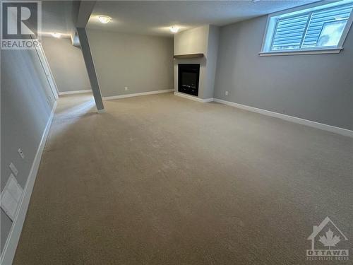 lower level (walkout) rec room - 608 Knotridge Street, Ottawa, ON - Indoor With Fireplace