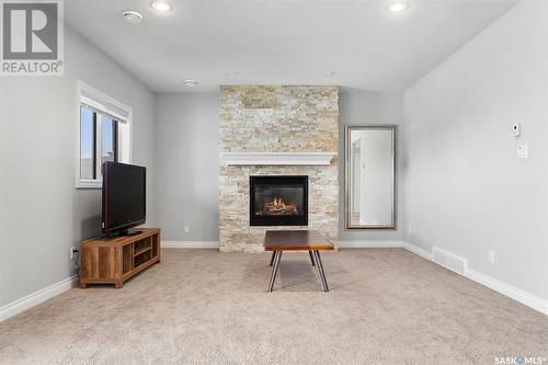 818 Ledingham Crescent, Saskatoon, SK - Indoor Photo Showing Other Room With Fireplace