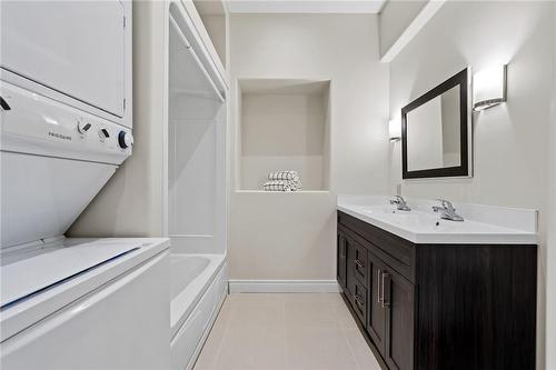 Suite #1 bathroom with own laundry facilities - 6771 Calaguiro Drive, Niagara Falls, ON - Indoor Photo Showing Laundry Room