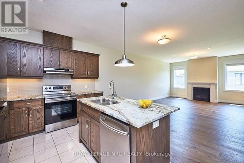 115 Borden Tr, Welland, ON - Indoor Photo Showing Kitchen With Fireplace With Double Sink