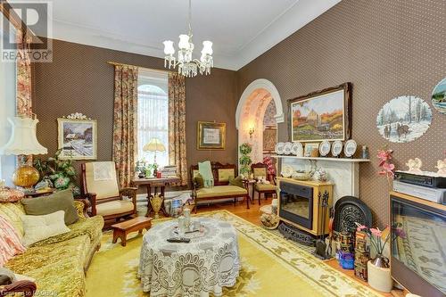 Parlor with electric insert in front of marble fireplace - 538 Queen Street N, Paisley, ON - Indoor With Fireplace