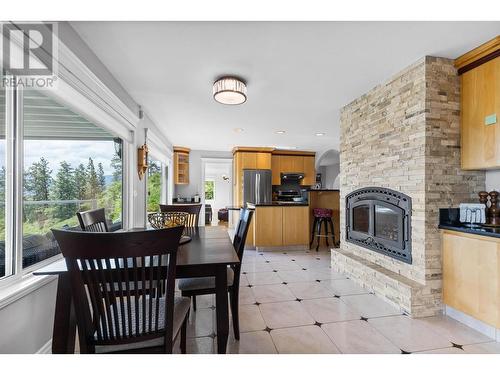 3380 Neid Road, Kelowna, BC - Indoor Photo Showing Dining Room With Fireplace