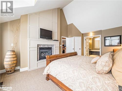 3876 Muskoka Road 118 Unit# Sandfield 5 W10, Port Carling, ON - Indoor Photo Showing Bedroom With Fireplace