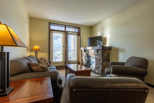 208 - 1545 Kicking Horse Trail, Golden, BC - Indoor Photo Showing Living Room With Fireplace