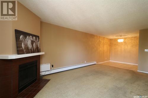 304 289 Fietz Street, Yorkton, SK - Indoor Photo Showing Other Room With Fireplace
