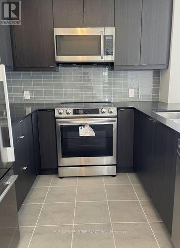 208 - 50 Thomas Riley Road, Toronto, ON - Indoor Photo Showing Kitchen With Stainless Steel Kitchen With Upgraded Kitchen