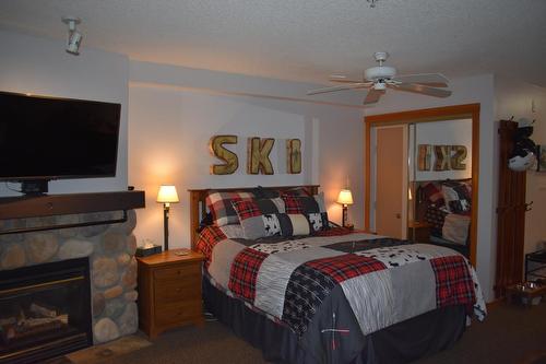 108 - 2060 Summit Drive, Panorama, BC - Indoor Photo Showing Bedroom With Fireplace