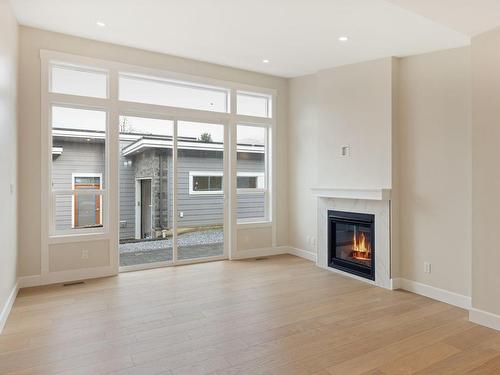 116-4690 Caspian Pl, Cowichan Bay, BC - Indoor Photo Showing Living Room With Fireplace