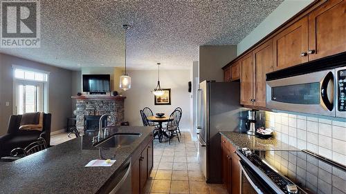 400 Bighorn Boulevard Unit# 412 A, Radium Hot Springs, BC - Indoor Photo Showing Kitchen With Fireplace