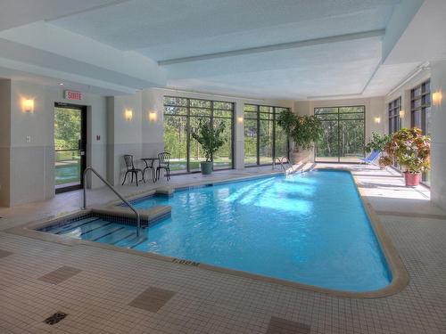 Piscine - 801-4500 Ch. Des Cageux, Laval (Chomedey), QC - Indoor Photo Showing Other Room With In Ground Pool