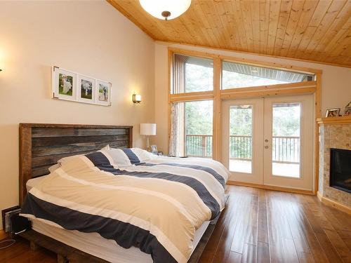 B-3208 Otter Point Rd, Sooke, BC - Indoor Photo Showing Bedroom With Fireplace