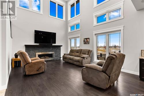 22 Aspen Village Drive, Emerald Park, SK - Indoor Photo Showing Living Room With Fireplace