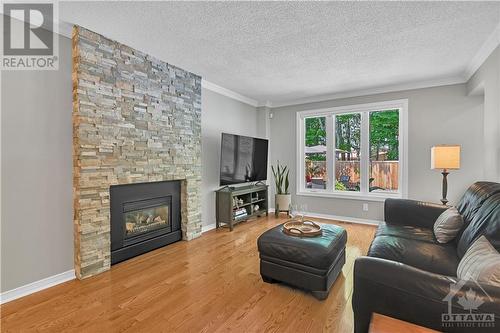 Family Room with Stone Fireplace - 1841 Hunters Run Drive, Ottawa, ON - Indoor Photo Showing Living Room With Fireplace