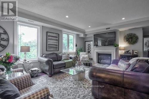 #306 -390 Upper Middle Rd E, Oakville, ON - Indoor Photo Showing Living Room With Fireplace