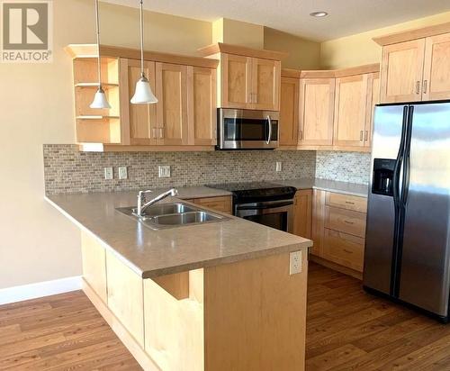 9100 Mackie Drive Unit# 211, Coldstream, BC - Indoor Photo Showing Kitchen With Stainless Steel Kitchen With Double Sink